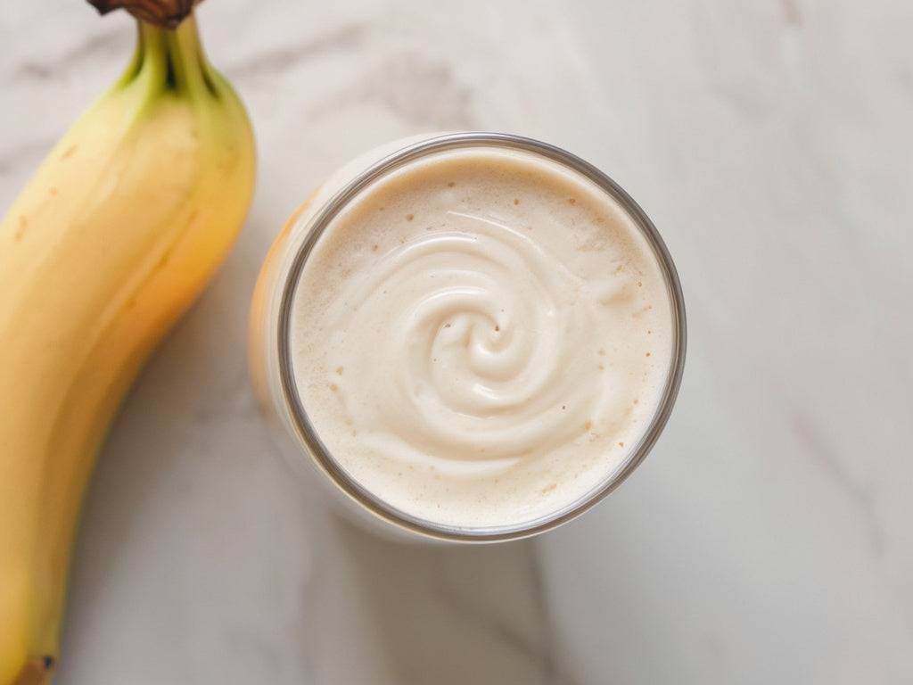 Creamy vanilla protein shake in a glass, overhead view