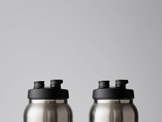 Close-up of stainless steel water bottles with different lid styles