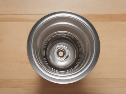 Top-down view into the wide open mouth of a stainless steel water bottle