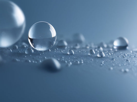 Macro close-up of water condensation droplets and dew beads on a cool blue surface