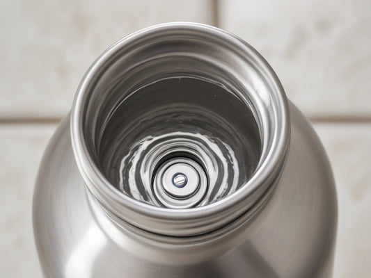Top-down view into the wide mouth of a stainless steel water bottle