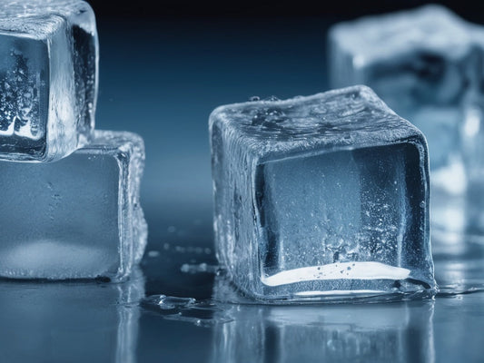 Close-up of cold clear ice cubes with water