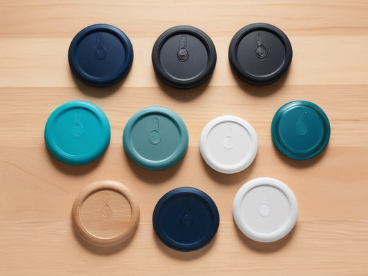 Flat-lay of assorted wide-mouth and standard-mouth water bottle lids on a wooden table