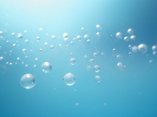 Fine bubbles rising through clear blue water