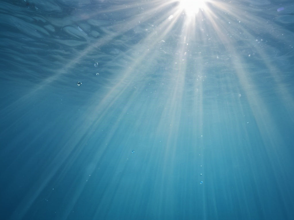 Underwater sunbeams through clear ocean water