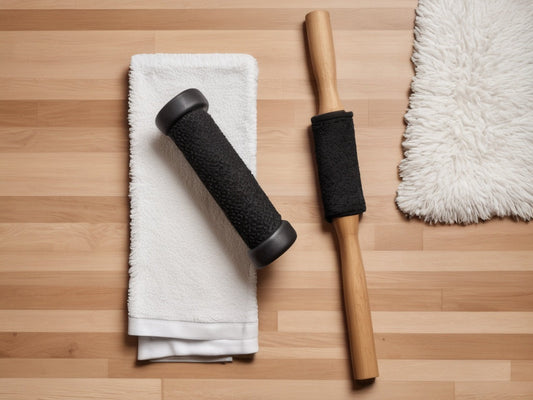 Massage roller stick and towel flat-lay on a gym floor