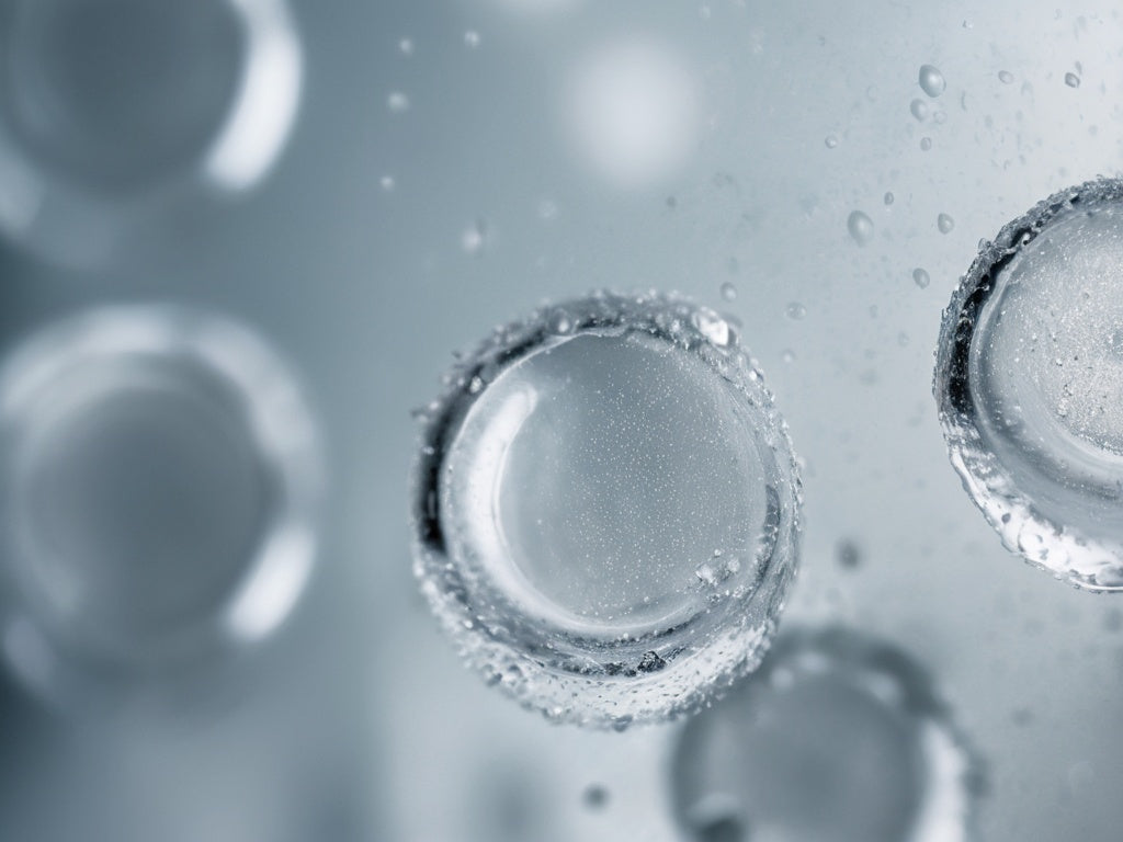 Close-up of a glass of ice water with cold condensation droplets