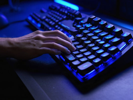 Close-up of hands on a backlit mechanical keyboard
